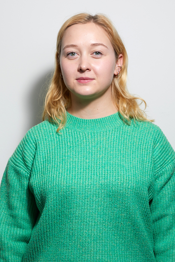 Staff photo of Josefine Bahro. She is wearing a green sweater and stands in front of a white wall.