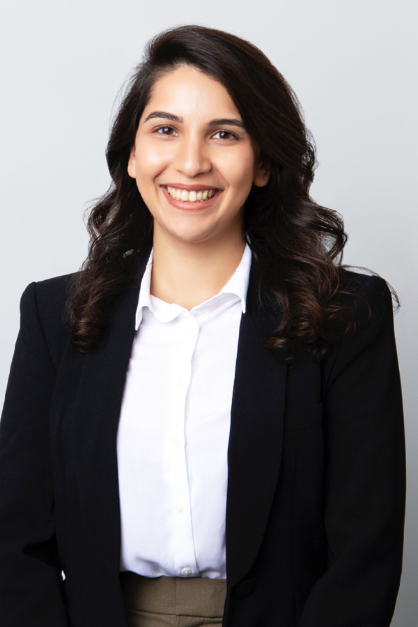 Staff photo of Lisa Soder. She is wearing a white blouse with black blazer and stands in front of a white wall.